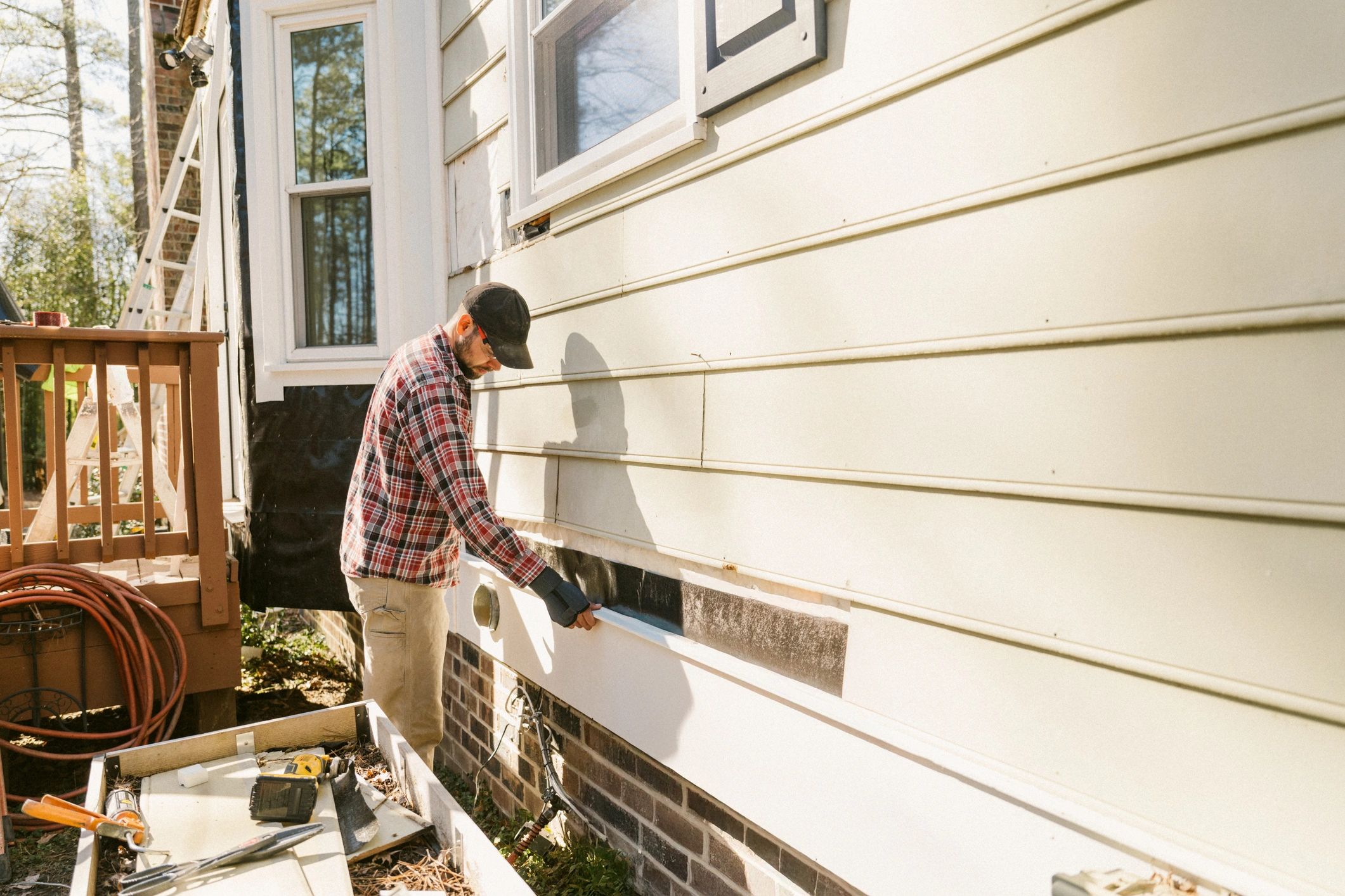 Service professional working on exterior home repairs