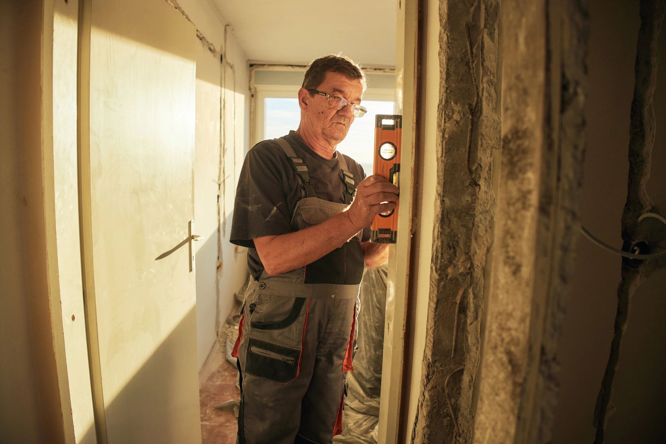 Contractor measuring and working carefully inside a home renovation project